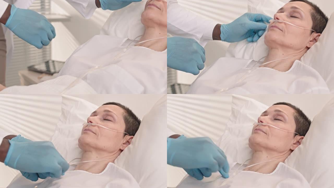 躺在医院病床上的鼻子里有氧气管的女人