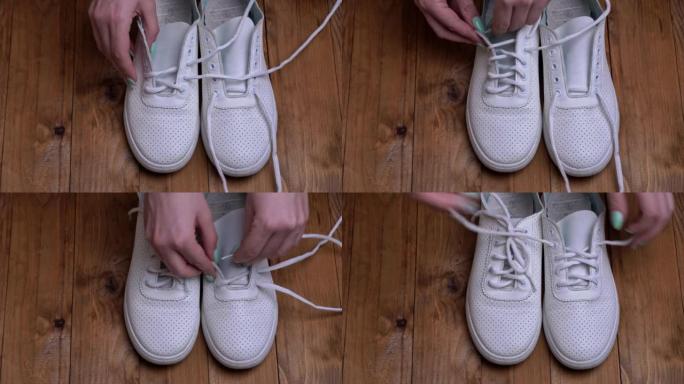 女孩的手在快节奏的镜头中系上白色运动鞋