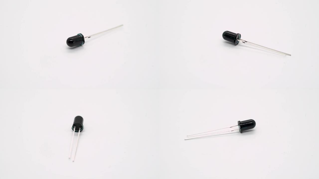 黑色发光二极管或火焰传感器电子元件在白色背景上旋转