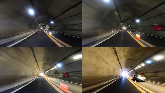 开车穿过高速公路隧道。隧道尽头的光