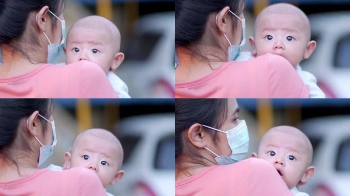 可爱，新生的亚洲男婴。家庭幸福，亚洲年轻的母亲带着爱去照顾。小无辜的新生婴儿在生命的第一天。母亲节概