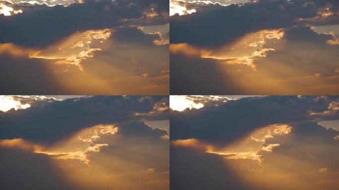 日落时黄色天空上快速移动的傍晚云的延时镜头。