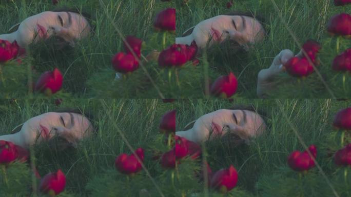 和谐的概念。在野生猩红色花朵的背景下，一个美丽的女人的脸。
