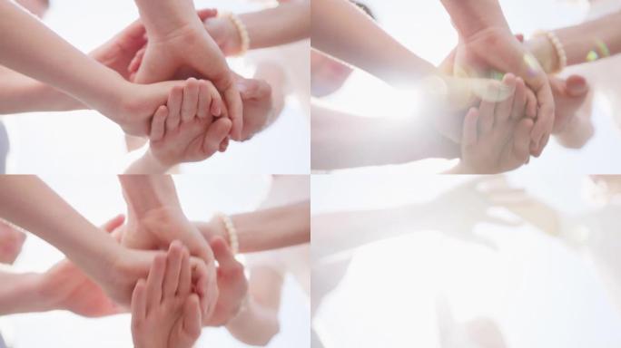 团队牵手或齐心协力，快乐的团队合作，支持或帮助团结