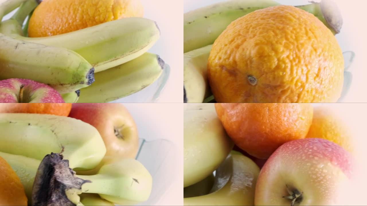旋转果盘配新鲜香蕉、苹果、橘子和橘子