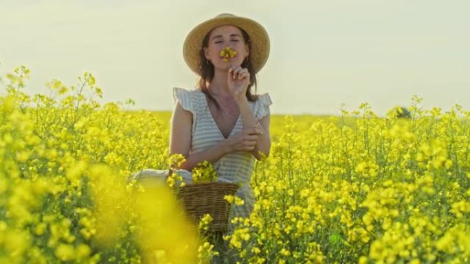 4k视频片段，一名年轻女子从乡下的田野里摘花