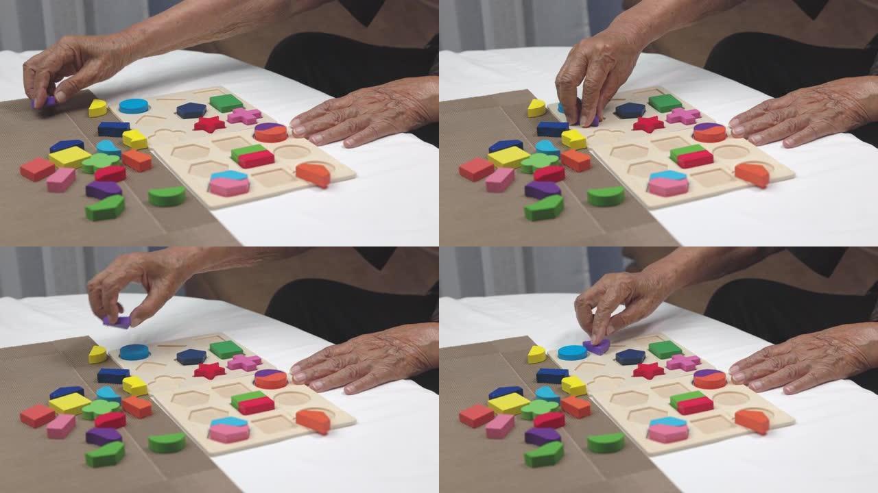 护理人员和老年妇女玩木制拼图游戏为痴呆症前期
