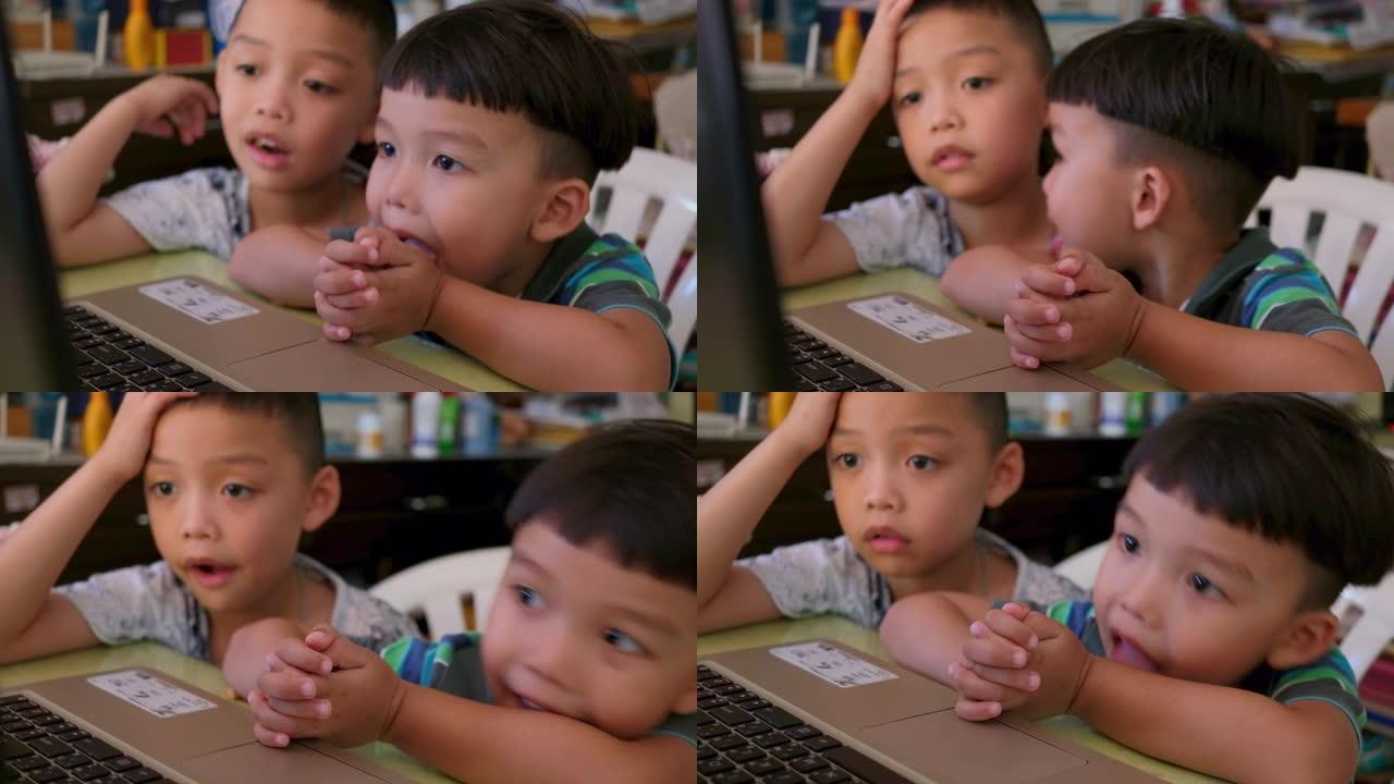 两个亚洲男孩不专心在家在线学习