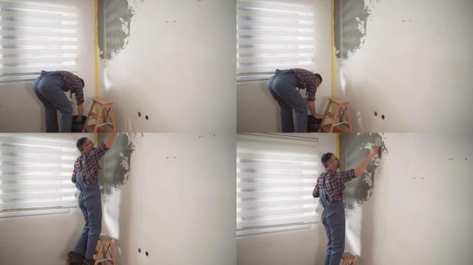 白种人建筑工人，在梯子上，用石膏涂墙壁
