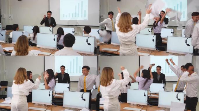 亚洲业务经理宣布好消息，激动人心的亚洲业务团队在办公室里激动人心，扔掉文件，以企业团队合作庆祝成功