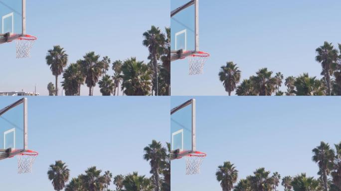 室外篮球场，橙色篮筐，篮球网和篮板。