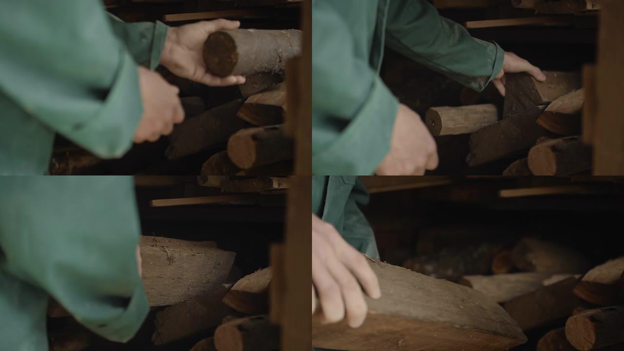 一位老人的手正在整理木头