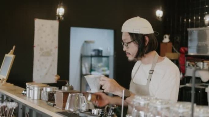 日本咖啡师将咖啡粉放入滤纸中准备做。浓缩咖啡。