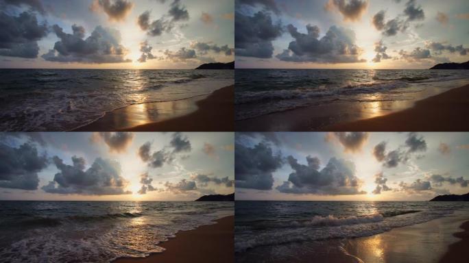 美丽的日落，沙滩上的阳光，沙滩上的海浪冲刷