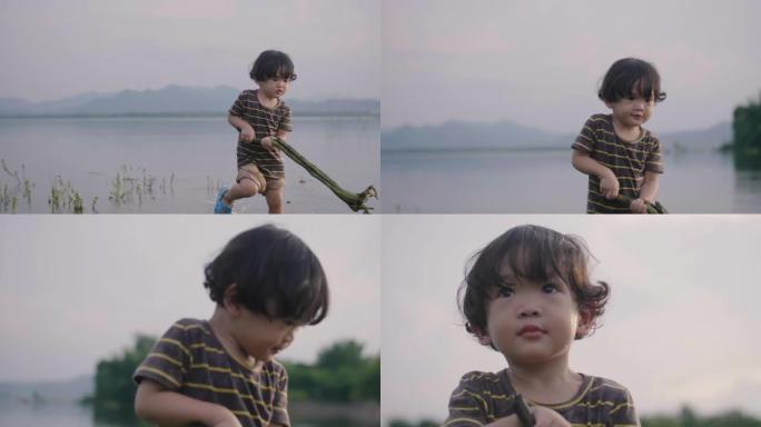 小男孩在河边玩耍。