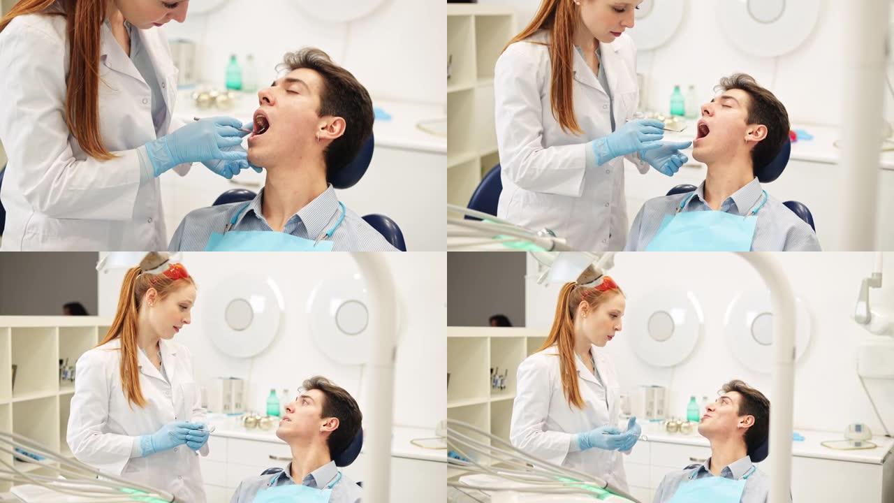 年轻的女牙医用口腔镜检查患者的牙齿和牙龈并建议治疗