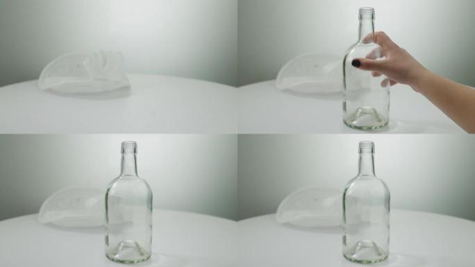 女性的手移开塑料瓶，将玻璃罐放在桌子上。无法识别的高加索年轻女子广告可持续生活方式特写。