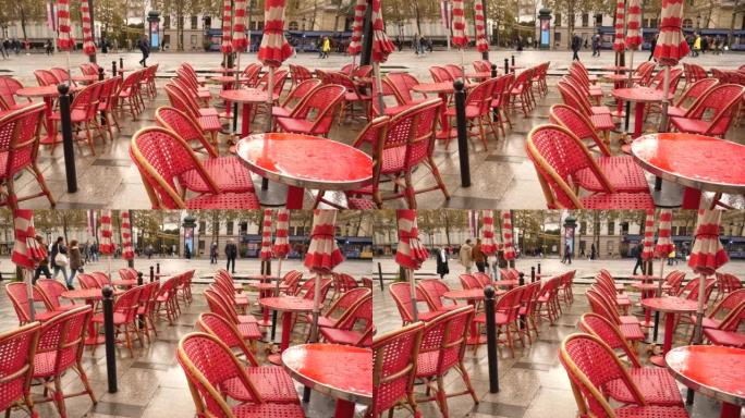 雨滴倒的湿红色桌子空了在巴黎市中心香榭丽舍大街的室外餐厅