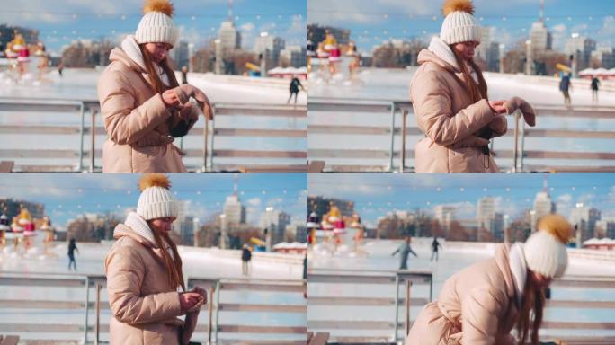 圣诞节假期，年轻的微笑女人在溜冰场中心城市广场上滑冰，在温暖的晴天活跃冬季休闲。手持效果。业余高加索