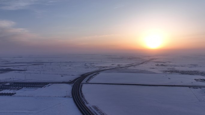 航拍4K雪域草原高速公路日出