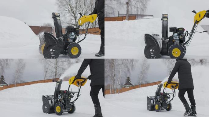 大雪过后，男人用木屋的扫雪机清理积雪。前视图。慢动作