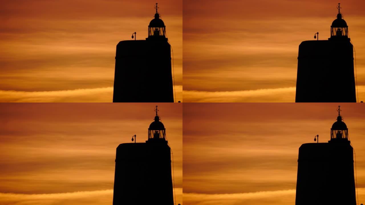 灯塔和西班牙的红色日落天空