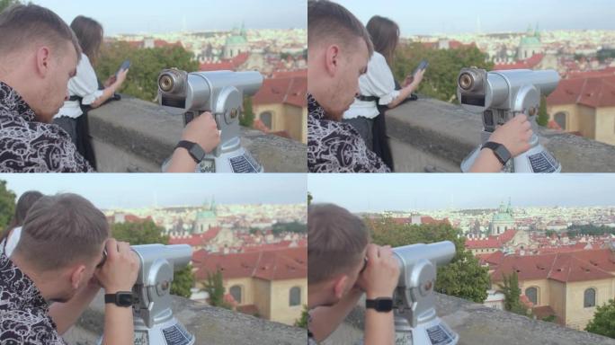 用旅游望远镜观察城市。布拉格。