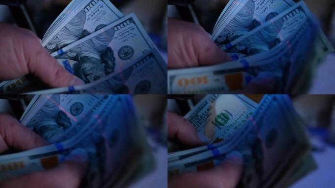 紫外线下的美元钞票。概念-检查美元的真实性。在钞票上搜索水印。