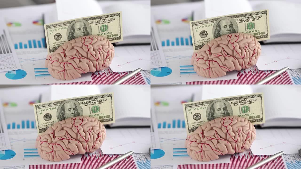 美元钞票被插入到带有图形的文件附近的人脑特写4k电影