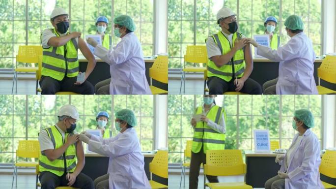 女医生在医院用注射器给亚洲工人注射新冠病毒疫苗，以防止欧米克隆冠状病毒的爆发