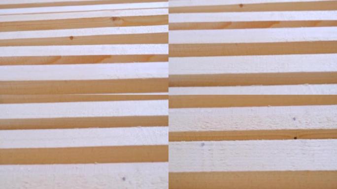 锯板位于彼此平行的地板上，用于干燥。准备在农村房屋中安装环保木地板。锯木厂的木材