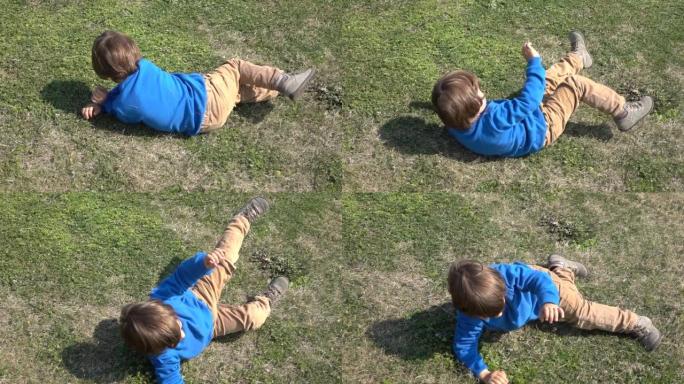 高清视频男孩在绿色的草地上滚动