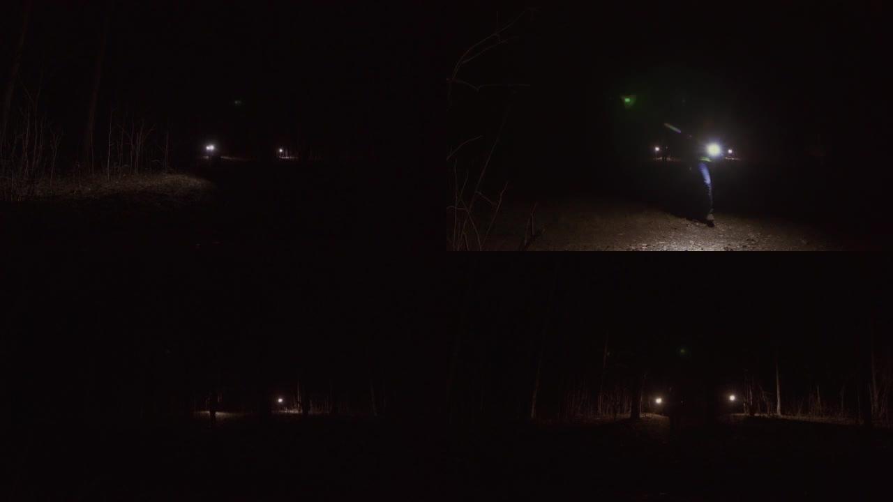 几个人穿着制服在夜林里用灯笼搜寻