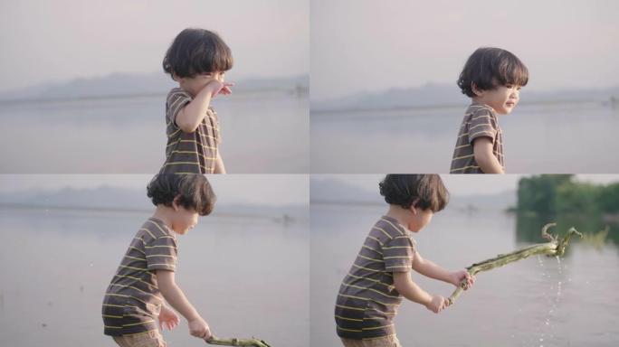 小男孩在河边玩耍。