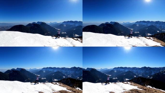 从奥地利卡林西亚卡拉万克斯雪山山峰的费拉彻角看风景的女人。山谷的泽尔普法尔山村。弗赖伯格的观点。朱利