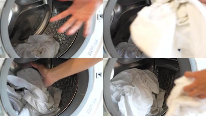 一个女人把白布放在洗衣机里