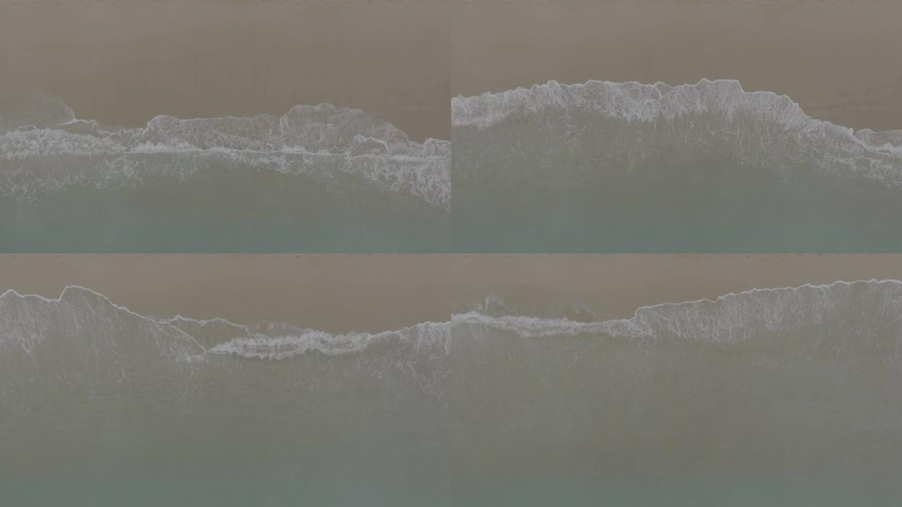 海浪在沙滩上滚动。沙滩上的波浪，度假的舒缓画面，海滩的鸟瞰图。海洋和陆地的交汇点。120 fps视频