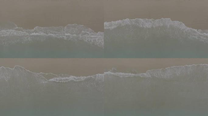 海浪在沙滩上滚动。沙滩上的波浪，度假的舒缓画面，海滩的鸟瞰图。海洋和陆地的交汇点。120 fps视频