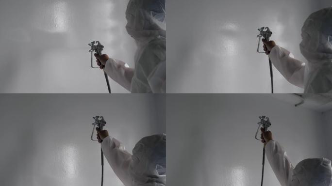 磨牙工人加工溶液在公寓墙壁上喷洒浸渍涂料