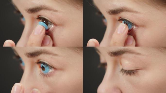 一个棕色眼睛的年轻女子用手指戴上蓝色装饰镜片的特写镜头。眼镜店概念。用于化妆和表演的彩色隐形眼镜广告