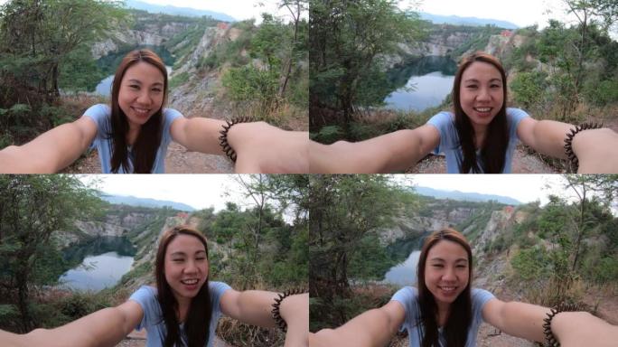 年轻的亚洲旅行者在泰国大峡谷的岩石悬崖上观光