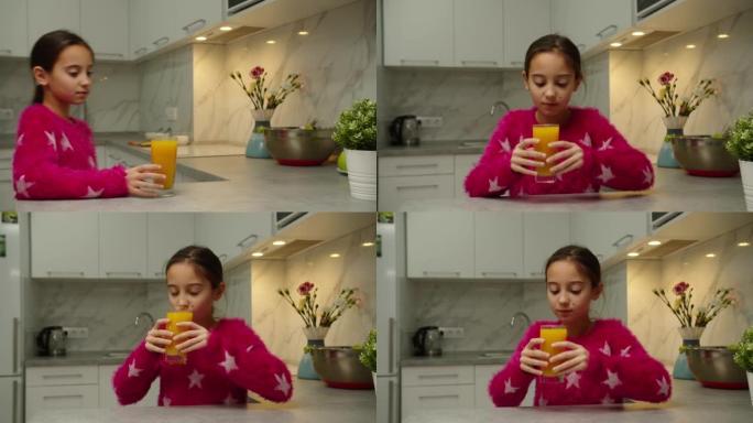 穿着粉色毛衣的害羞的青春期女孩在家喝杯橙汁