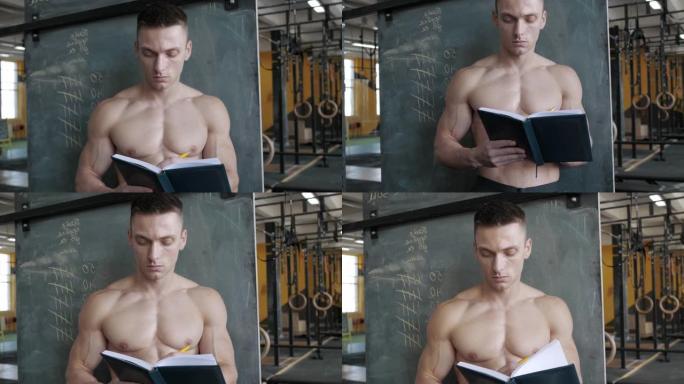 肌肉发达的运动员在健身房的笔记本上写结果。运动，举重和保健概念