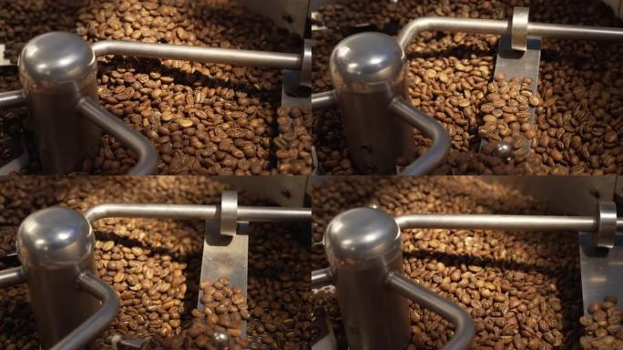 咖啡烘焙过程中的咖啡烘焙机。烤纺纱冷却器专业机器和棕色咖啡豆机芯在工厂关闭。咖啡馆的餐饮背景。慢动作