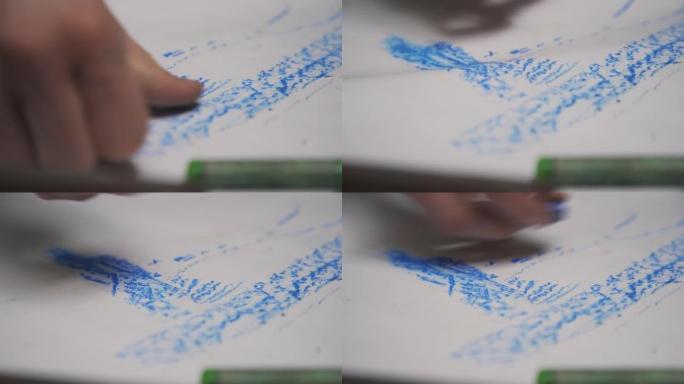 艺术家用手在一块用彩色蜡笔的大画布上画了一幅画