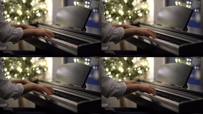 一位钢琴家音乐家在圣诞树旁弹奏数码钢琴
