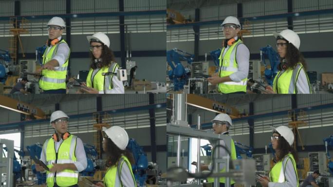4k男女工程师检查机械臂运动以控制现代工厂的自动化生产线的质量