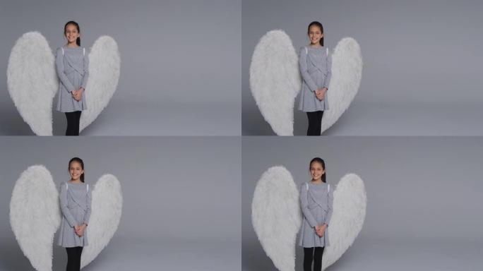 工作室拍摄肖像女孩戴着天使翅膀