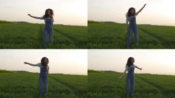 一个快乐的年轻女孩正在田野中跳跃和玩耍