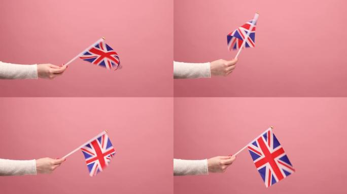 6月4日:英国独立日，妇女手中举着英国组成单位的旗帜。